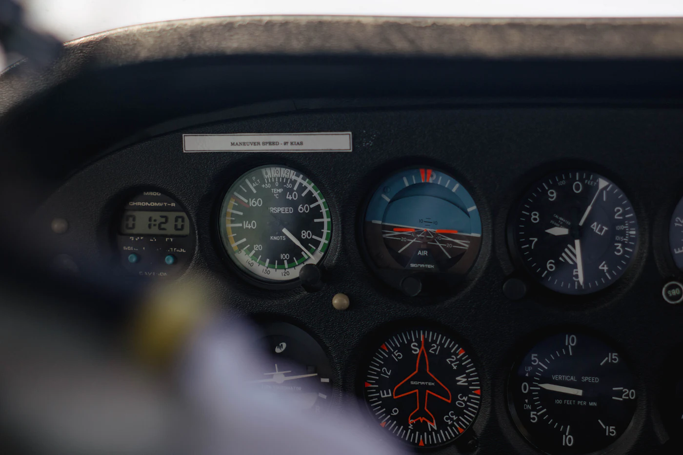 Close-up of an airplane instrument panel with analog flight gauges